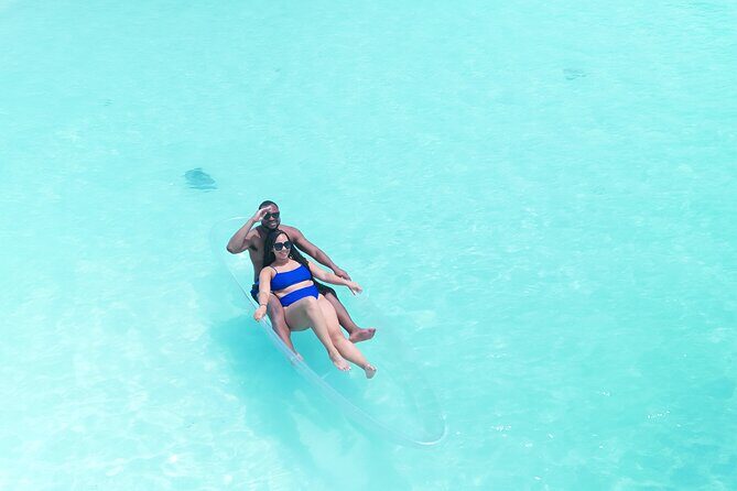 Romantic Clear Kayak Drone Photoshoot for Couples Turks & Caicos - Getting Into the Transparent Kayak in Shallow Water